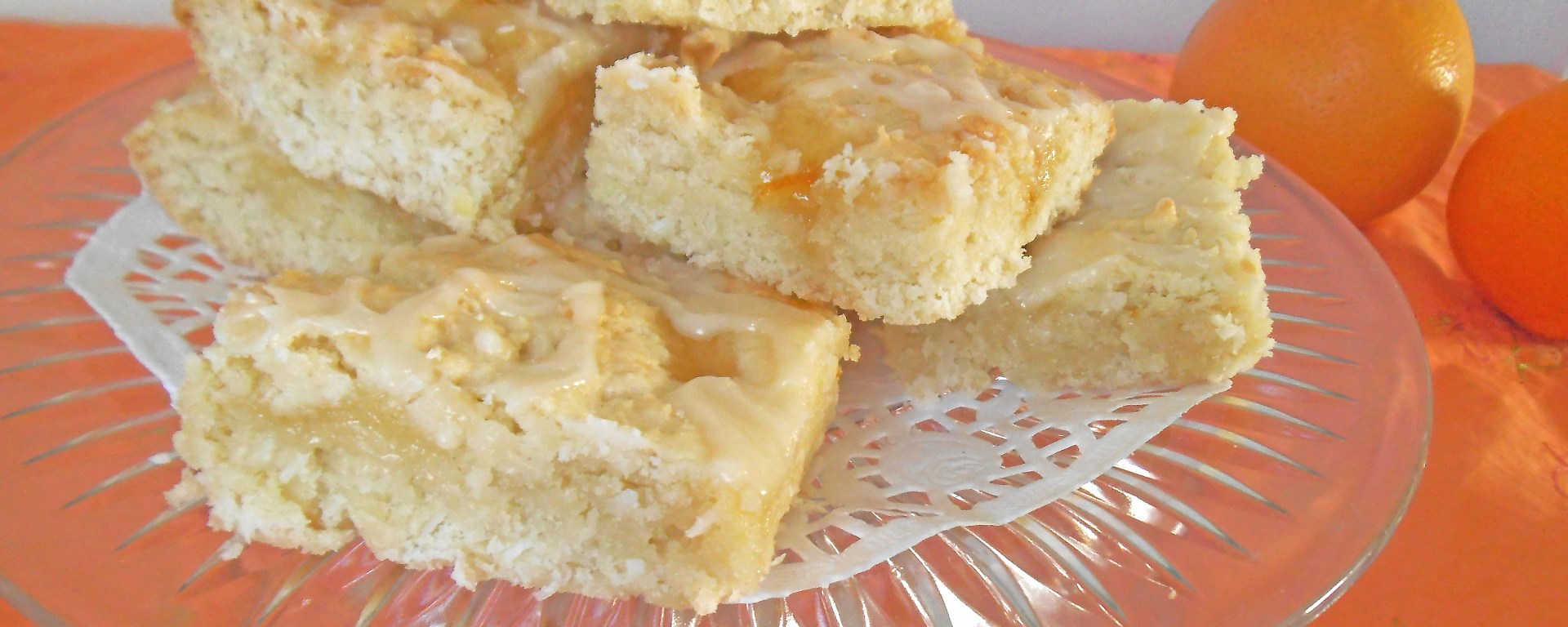 Marmalade-swirled lemon cookie squares on a glass serving platter
